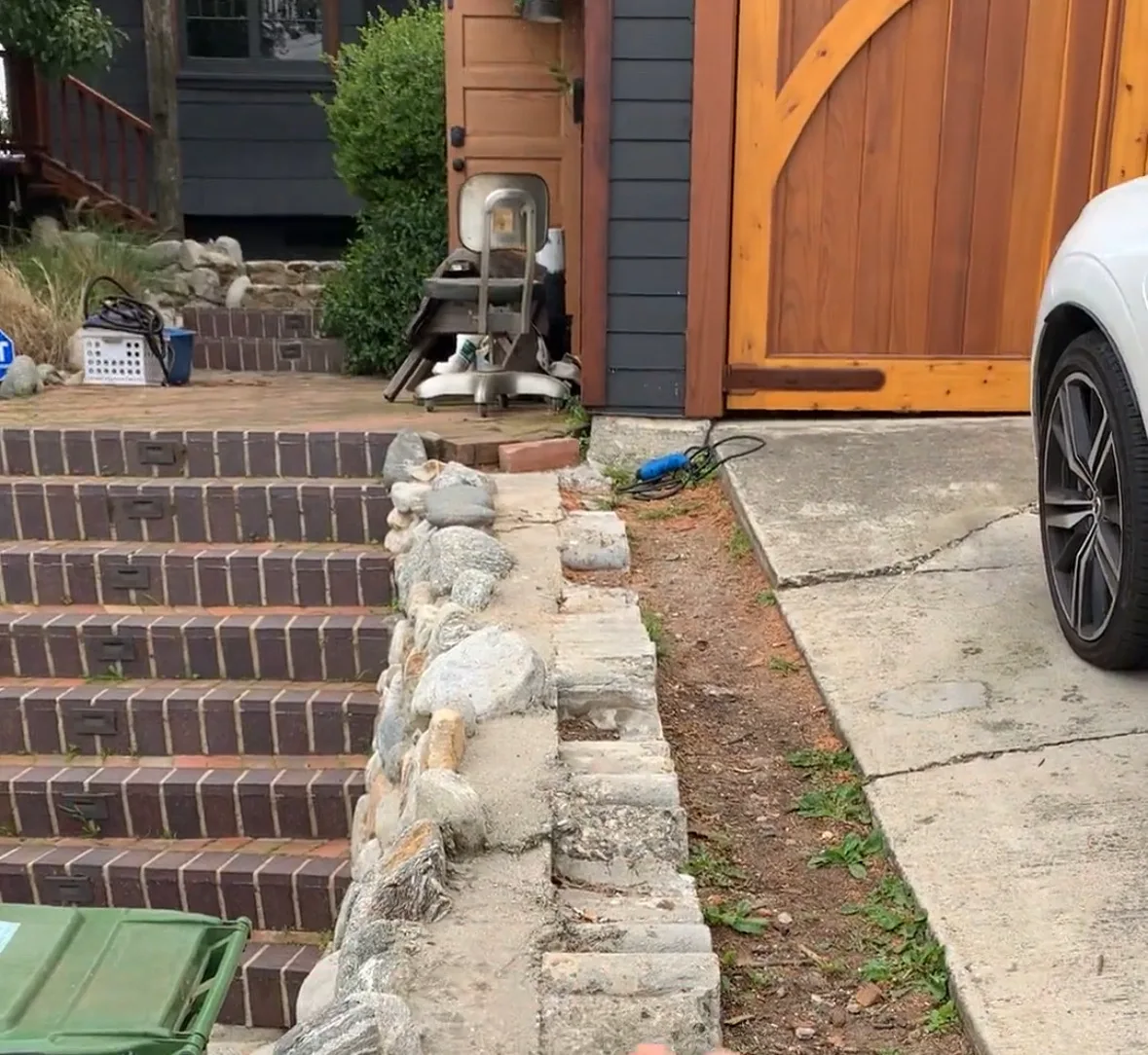 Clay brick steps bordered in river rock on a Camberos Masonry job