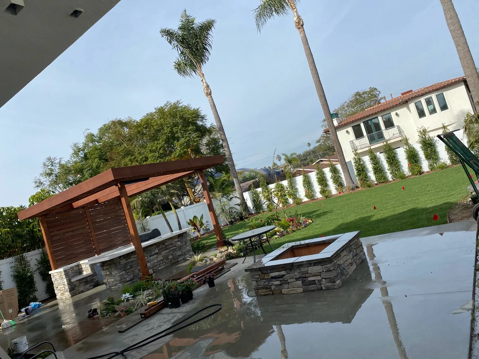 Backyard with masonry hardscape, pergola and fire pit