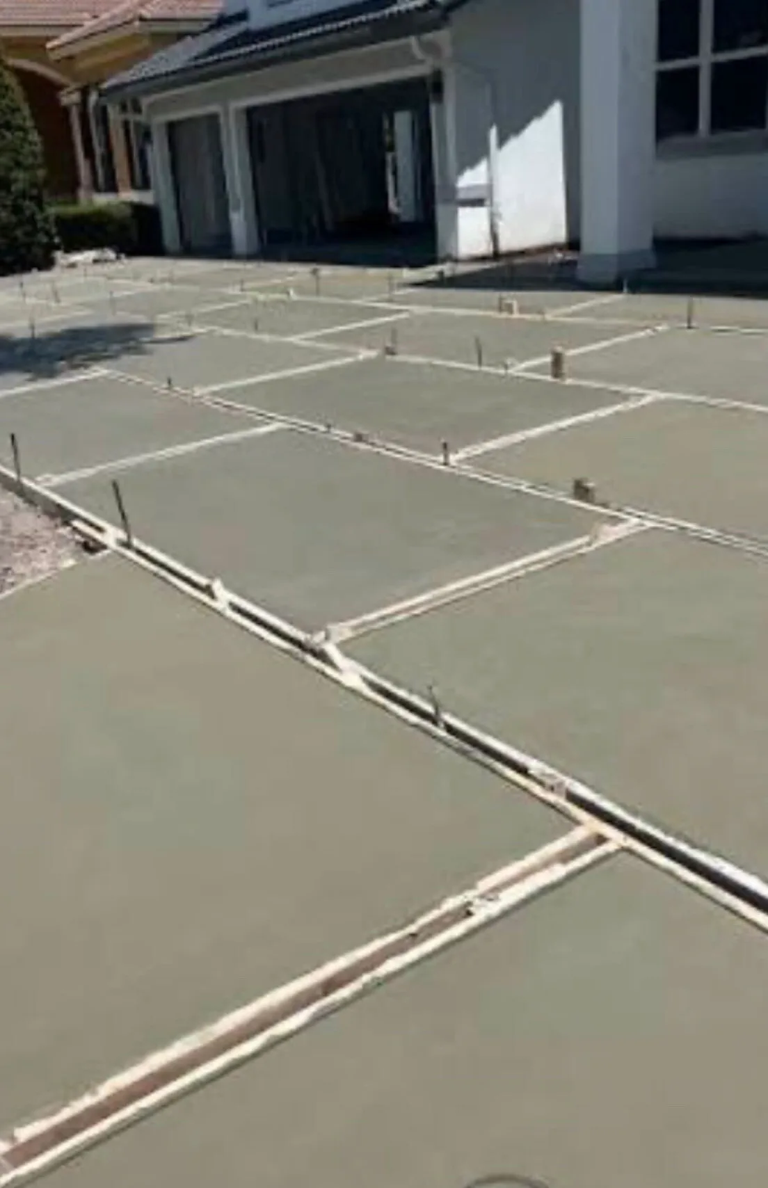 Turf-strip pad driveway during the pour, pads formed and floated